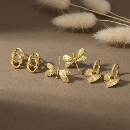 K-A Trends anti tarnish gold earrings combo set featuring double loop studs, dragonfly studs and heart hoop earrings premium jewellery flatlay
