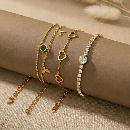K-A Trends anti tarnish gold bracelet stack with emerald stone charm, heart chain bracelet and crystal tennis bracelet layered wrist styling