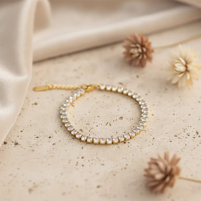 Gold tennis bracelet features sparkling stones set in a sleek gold-plated design. It is anti-tarnish and lightweight.