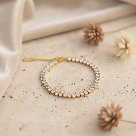 Gold tennis bracelet features sparkling stones set in a sleek gold-plated design. It is anti-tarnish and lightweight.