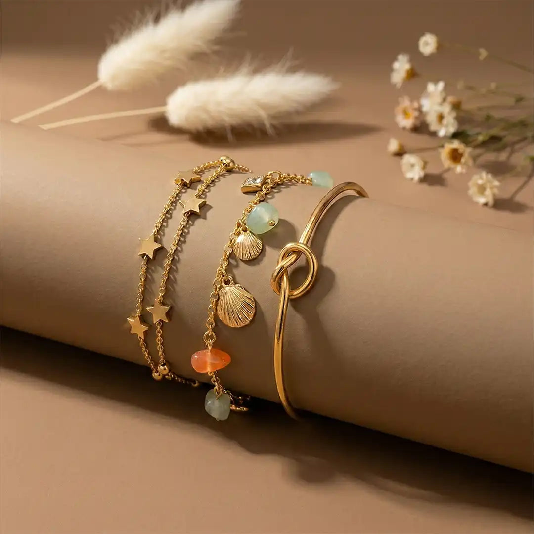 K-A Trends anti tarnish gold bracelet stack with star charm chain, shell bead bracelet and knot bangle premium layered wrist look