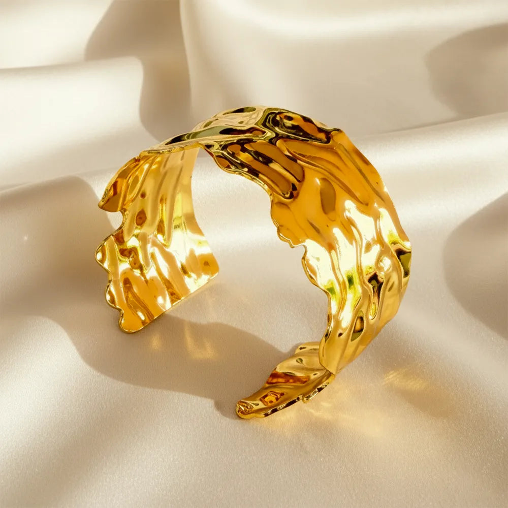 This golden wave cuff features a flowing molten design with a high-shine It is adjustable and anti-tarnish