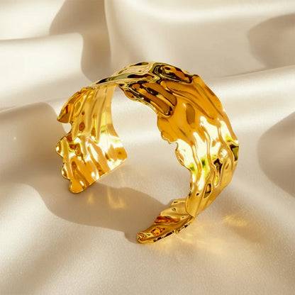 This golden wave cuff features a flowing molten design with a high-shine It is adjustable and anti-tarnish