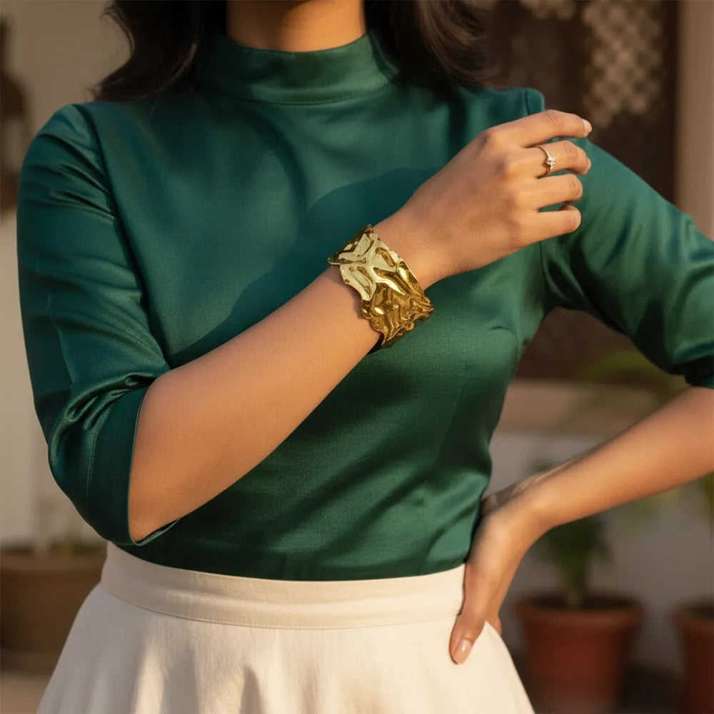 This golden wave cuff features a flowing molten design with a high-shine It is adjustable and anti-tarnish