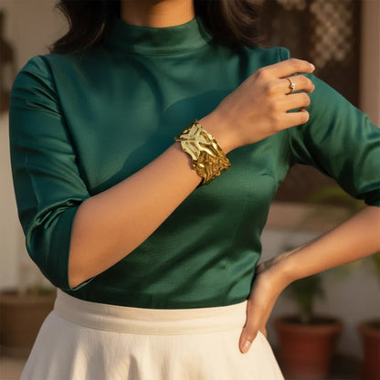 This golden wave cuff features a flowing molten design with a high-shine It is adjustable and anti-tarnish