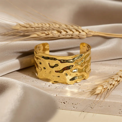 This golden wave cuff features a flowing molten design with a high-shine It is adjustable and anti-tarnish