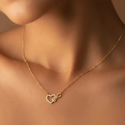 A delicate necklace with a heart-shaped pendant intertwined with an infinity symbol, accented with small crystals.