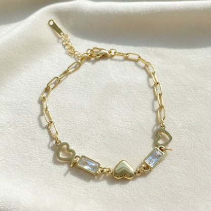 Anti-tarnish heart-link gold bracelet features a stylish chain design with a heart and crystal charms.