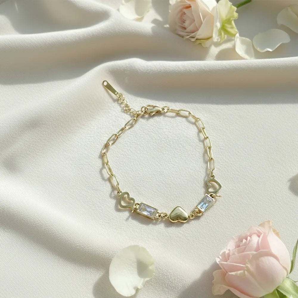 Anti-tarnish heart-link gold bracelet features a stylish chain design with a heart and crystal charms.