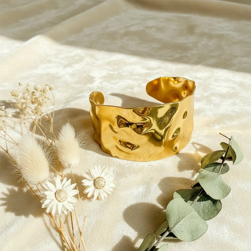 This textured glow bracelet features a hammered gold-plated design with a smooth adjustable fit.