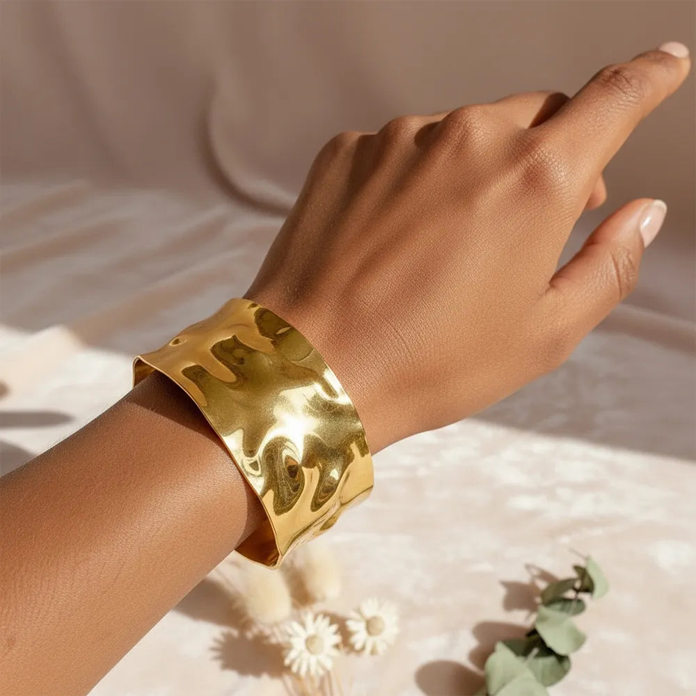 This textured glow bracelet features a hammered gold-plated design with a smooth adjustable fit.