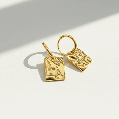 Square Drops, featuring a unique textured finish that adds a modern touch to any outfit.