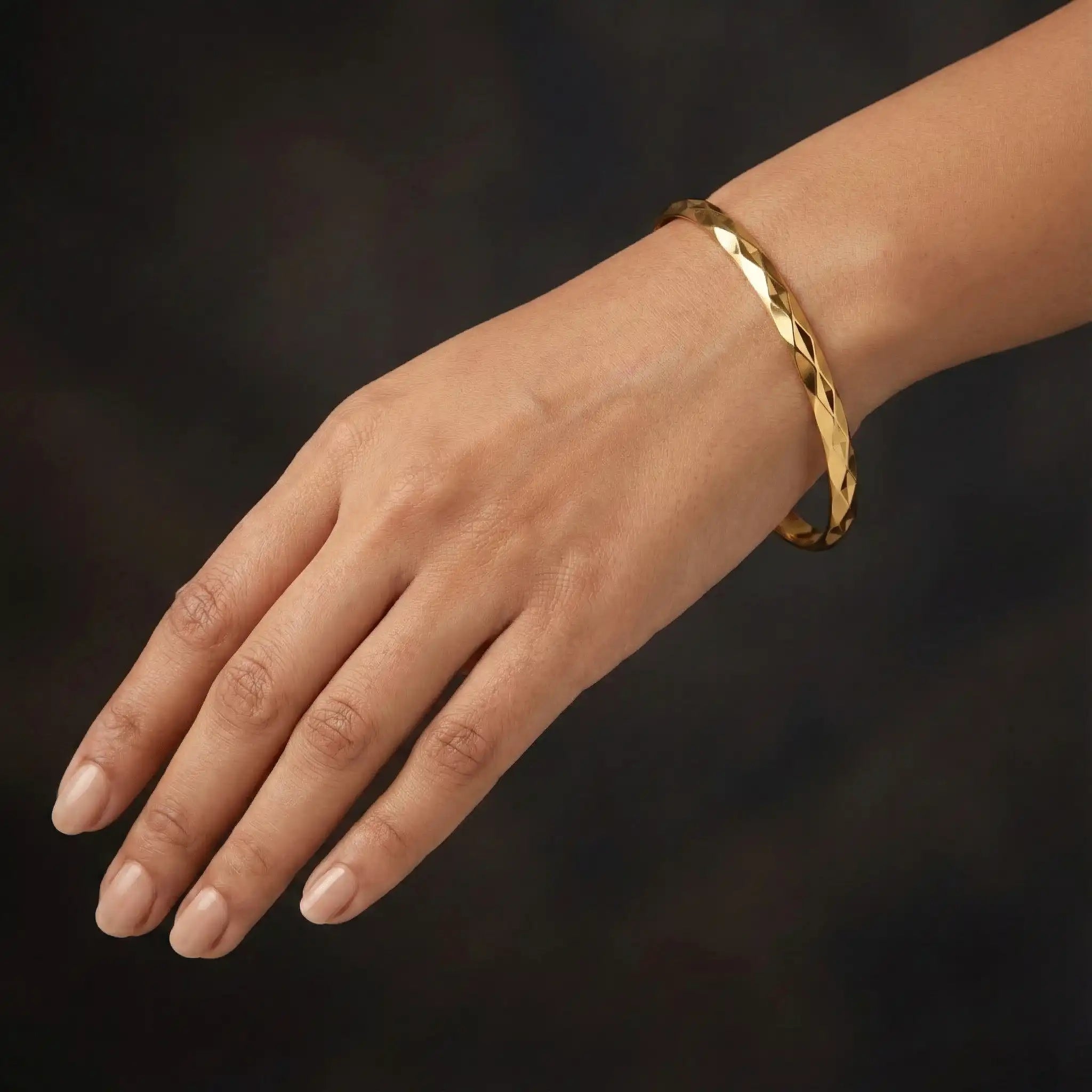 Diamond Cut Bangle anti-tarnish gold bangle styled on dark luxury background