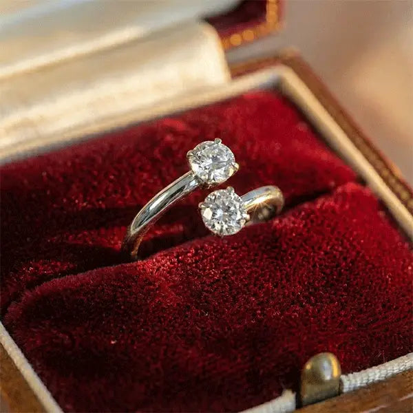 Silver finish two stone open AD ring with crystal studs displayed in a velvet jewelry box