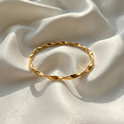 2 Swirl Gold Bangle anti-tarnish gold bangle with twisted swirl design on white satin