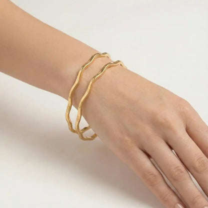 K-A Trends gold wave bangles pair on female wrist, anti-tarnish stylish bracelet for women