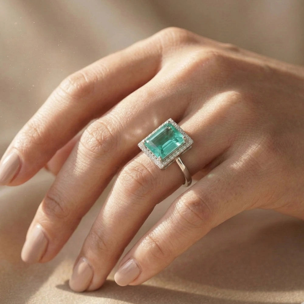 Elegant aqua royale AD adjustable ring with AD halo stones worn on hand, shining in soft natural sunlight.