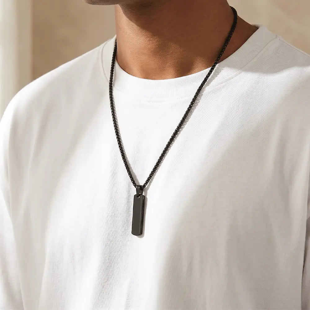 Man wearing sleek black bar pendant necklace with modern stainless steel chain and anti-tarnish finish by K-A Trends