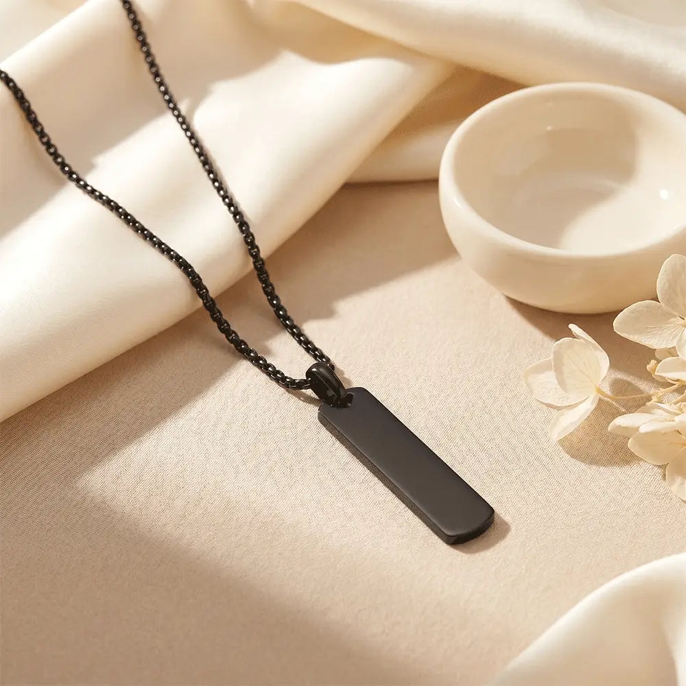 Minimalist black bar pendant necklace for men displayed on elegant beige background with premium styling from K-A Trends