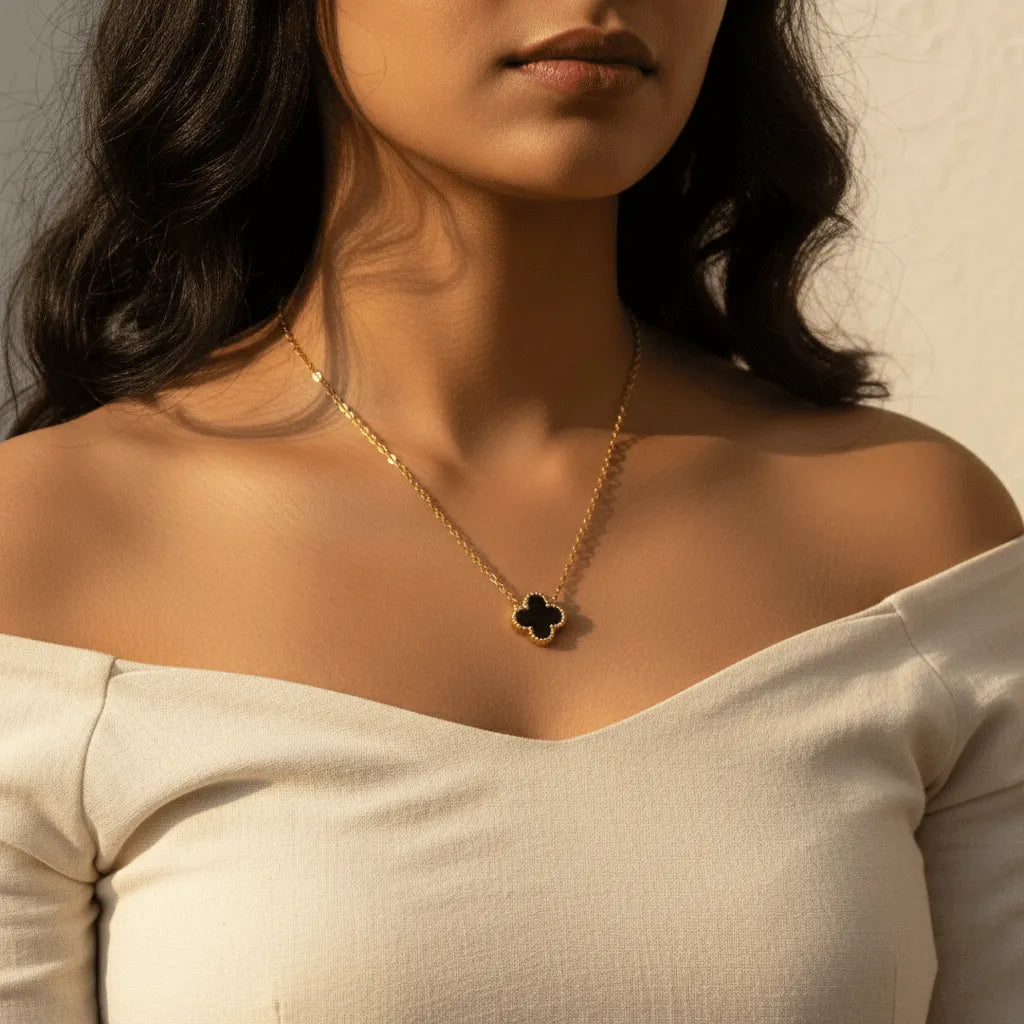 Close-up showing the reversible clover pendant with anti-tarnish finish, highlighting both elegant black and white faces.