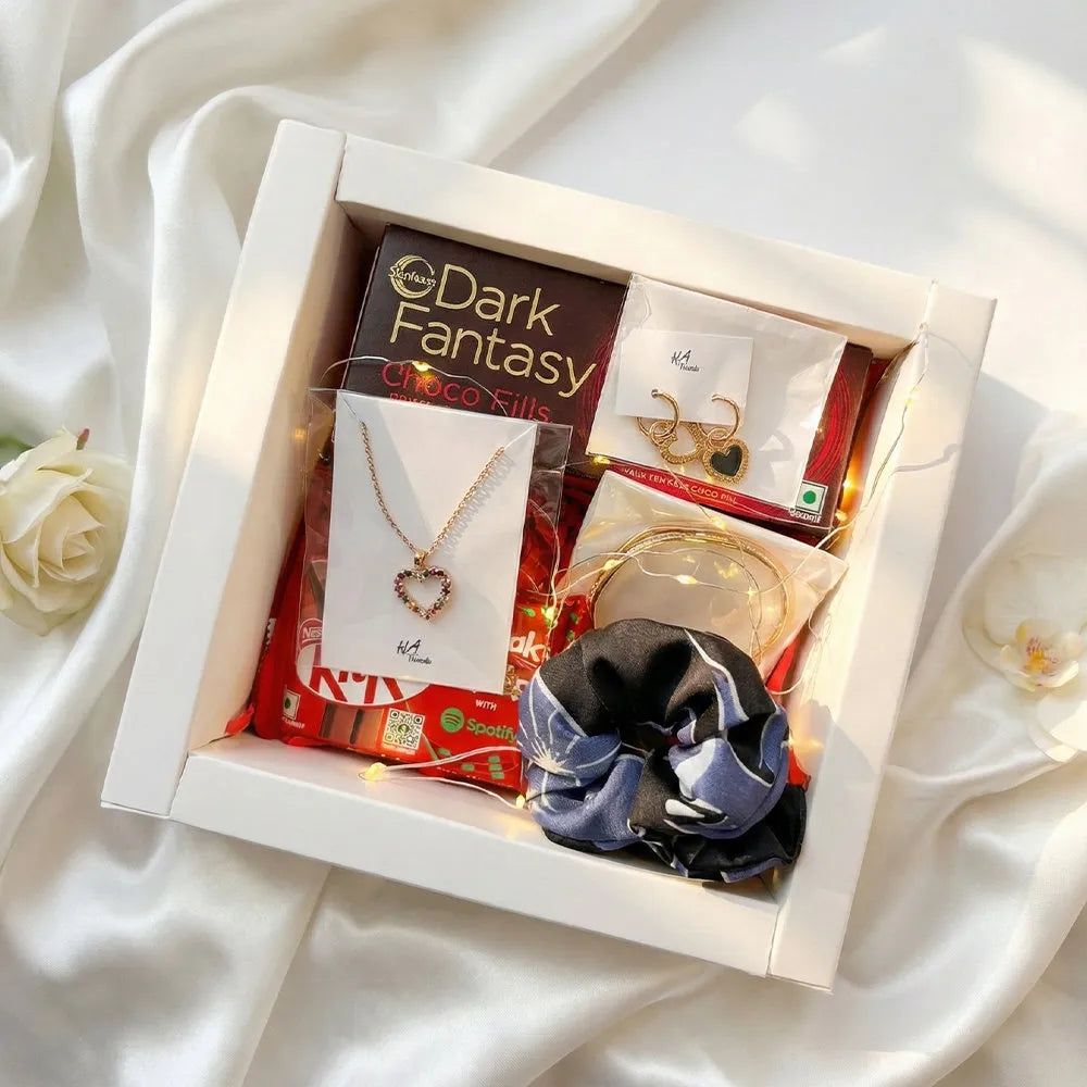 Luxury Valentine gift hamper with anti-tarnish heart necklace, gold earrings, bangle, chocolates, scrunchie, fairy lights, and premium white packaging