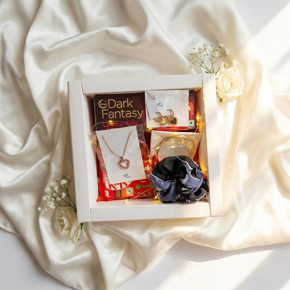 Premium Valentine hamper with anti-tarnish heart pendant necklace, matching earrings, chocolates, scrunchie, and warm fairy lights in luxury gift box