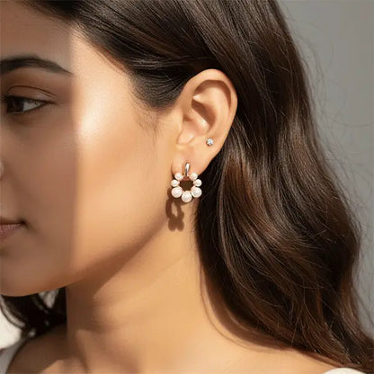 Woman wearing elegant blush pearl drop earrings with rose-gold circular design – lightweight anti-tarnish statement jewellery.