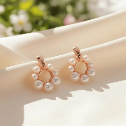 Close-up of blush pearl drop earrings featuring rose-gold circular frame and glossy white pearls – premium women’s fashion jewellery.