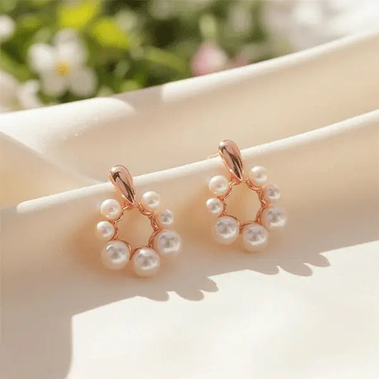 Close-up of blush pearl drop earrings featuring rose-gold circular frame and glossy white pearls – premium women’s fashion jewellery.