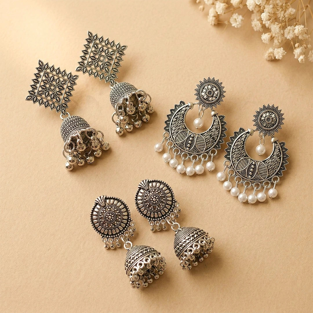 Set of 3 boho oxidised silver earrings featuring boho jhumka, noor bali jhumka, and ornate square jhumka displayed on a beige background.