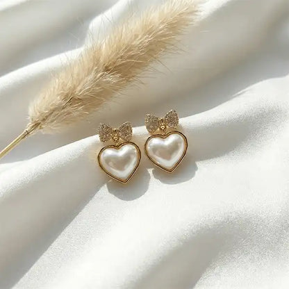 Bow heart pearl drop earrings with pearl heart design on white satin fabric, anti-tarnish everyday jewellery
