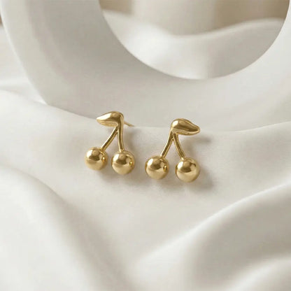 Close up of cherry drop stud earrings in polished gold finish, lightweight anti tarnish everyday studs for women