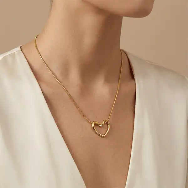 Woman wearing a minimalist gold heart pendant necklace on a western outfit, anti-tarnish jewellery for everyday wear