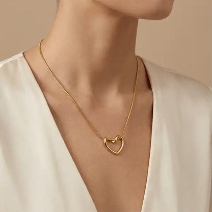 Woman wearing a minimalist gold heart pendant necklace on a western outfit, anti-tarnish jewellery for everyday wear