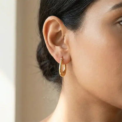 Classic Textured Hoops Anti-Tarnish gold earrings worn in ear close-up