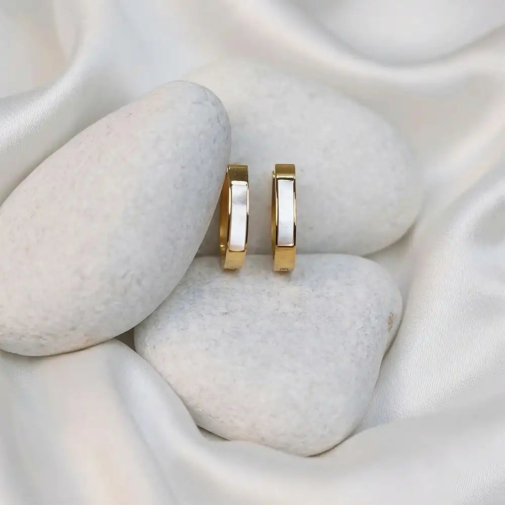 Classic Slim Hoops on a textured white surface with stones