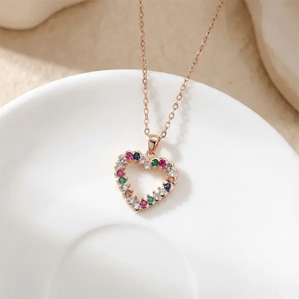 Colorful Love Pendant heart-shaped necklace with multicolour stones placed on white ceramic plate