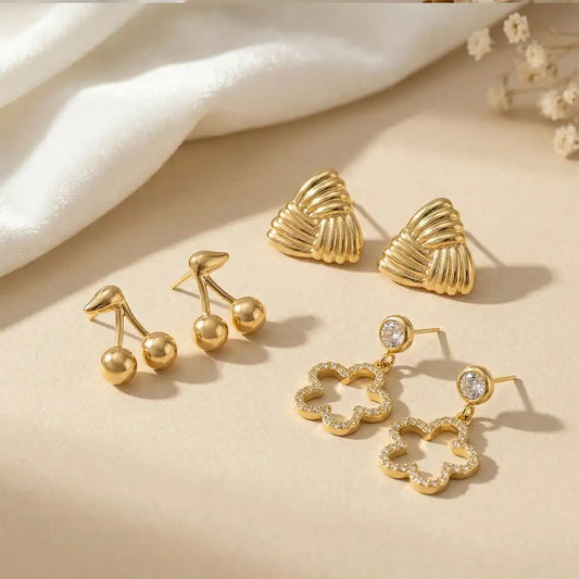 K-A Trends anti tarnish gold earrings combo with cherry studs, textured shell studs and crystal clover drop earrings elegant everyday wear