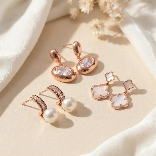 K-A Trends anti tarnish rose gold earrings combo featuring pearl drop studs, crystal oval drops and clover dangle earrings elegant party wear