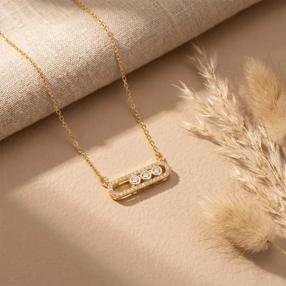 Premium gold crystal pendant necklace with sparkling stone detailing on soft beige aesthetic background from K-A Trends