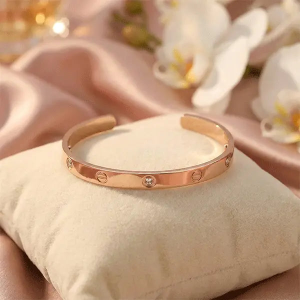 Crystal rose gold bracelet with embedded stones, anti-tarnish open cuff design displayed on a soft cushion