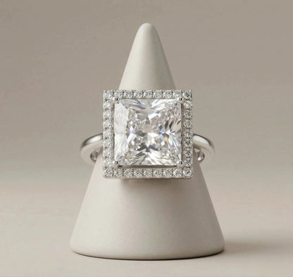 Square crystal AD adjustable ring on minimal cone jewellery display stand, silver halo setting with large princess-cut stone