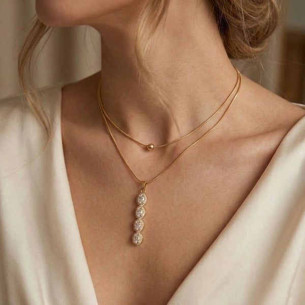 Crystal Drop Layered Pendant - Anti-Tarnish on a person wearing a white top.