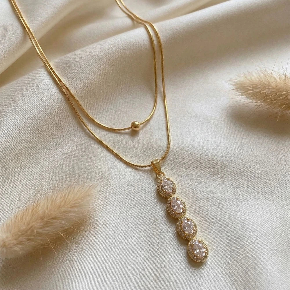 Crystal Drop Layered Pendant - Anti-Tarnish on a white satin cloth.