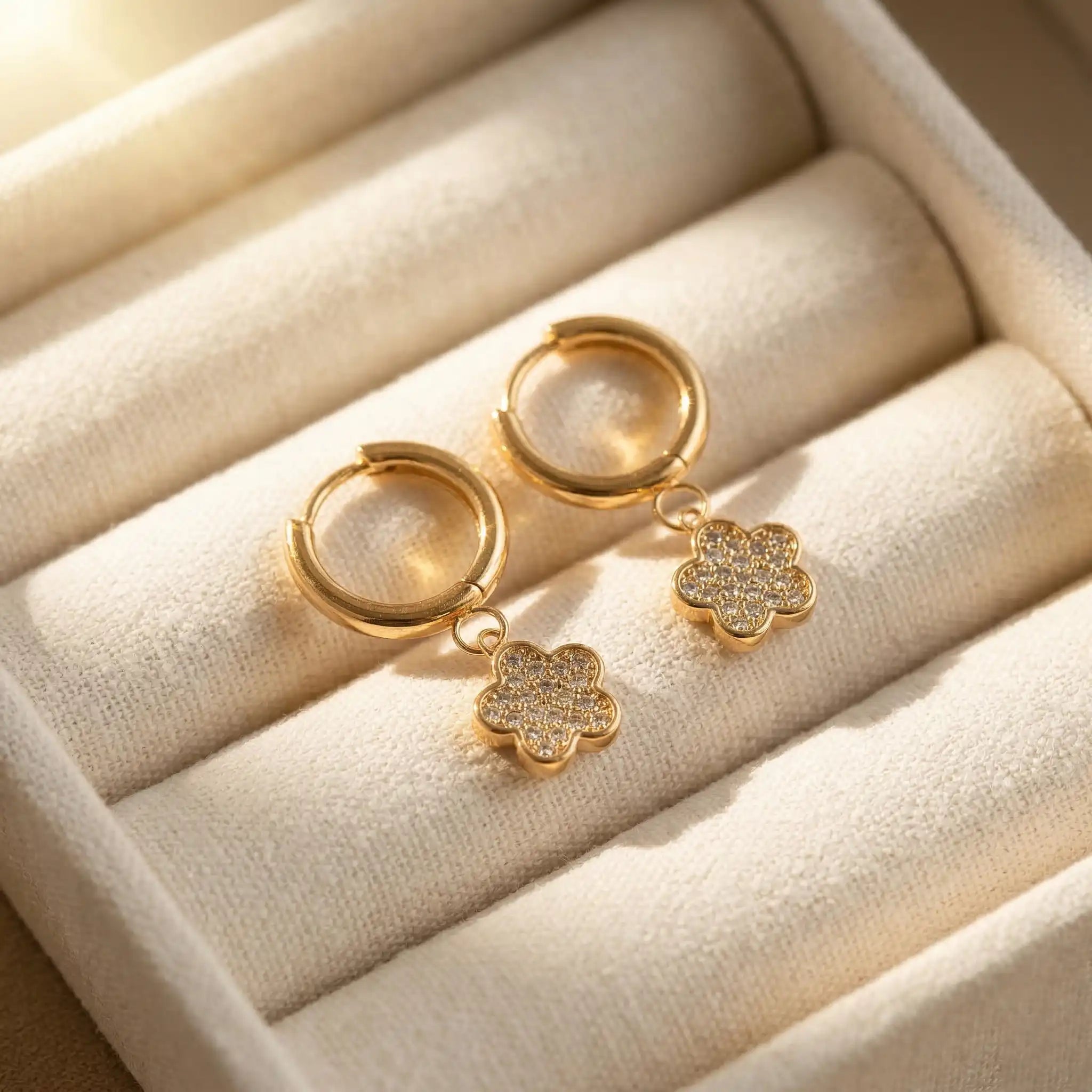 Crystal Flower Hoops with floral designs on a beige jewelry box