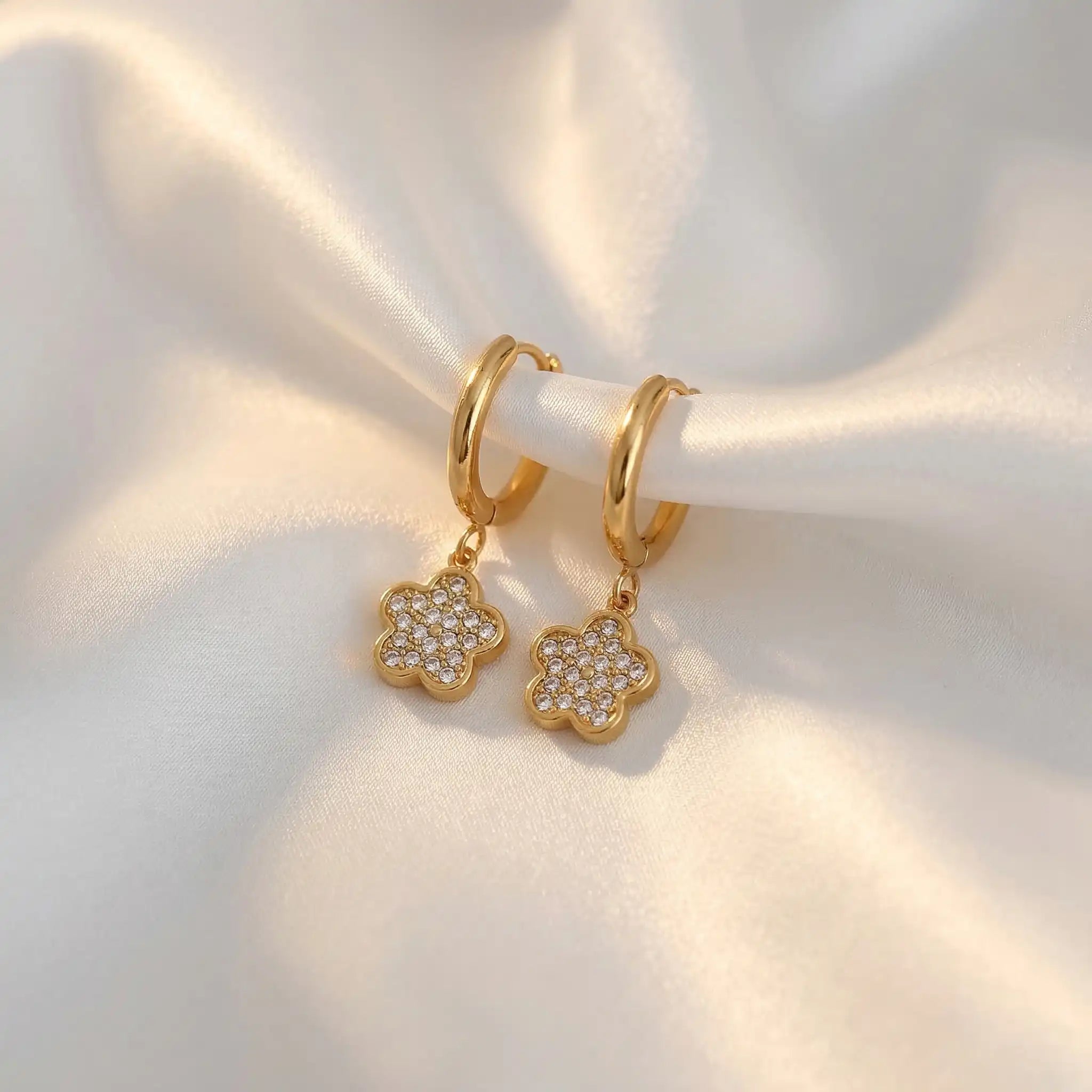 Crystal Flower Hoops with floral charms on a soft white background