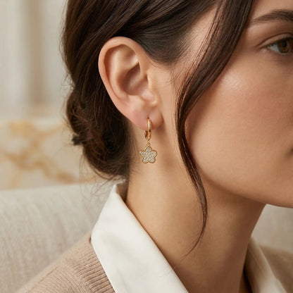 Close-up of a woman wearing  Crystal Flower Hoops with a blurred background