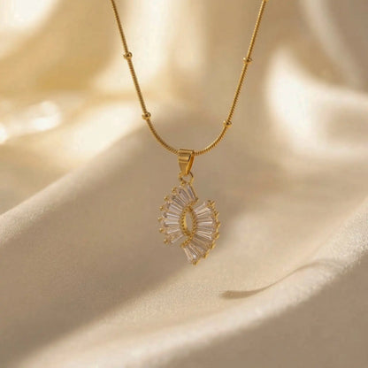 Crystal Halo Fan Penadant with a diamond pendant on a beige fabric background