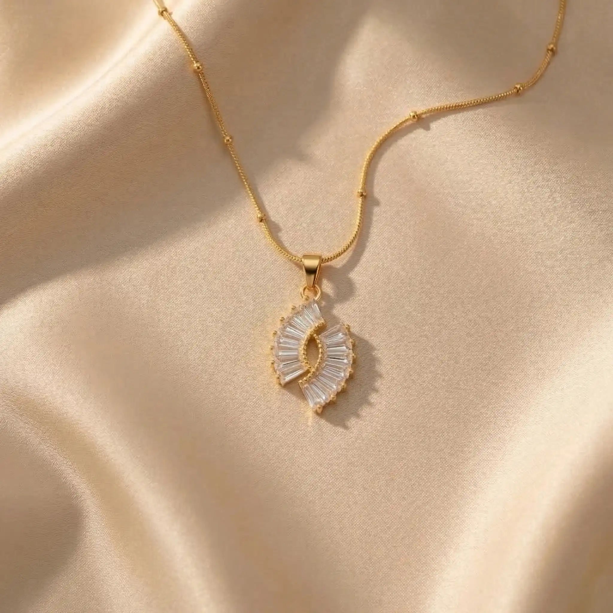 Crystal Halo Fan Penadant on a beige fabric background