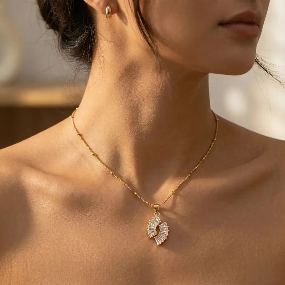 Close-up of a person wearing a Crystal Halo Fan Penadant.